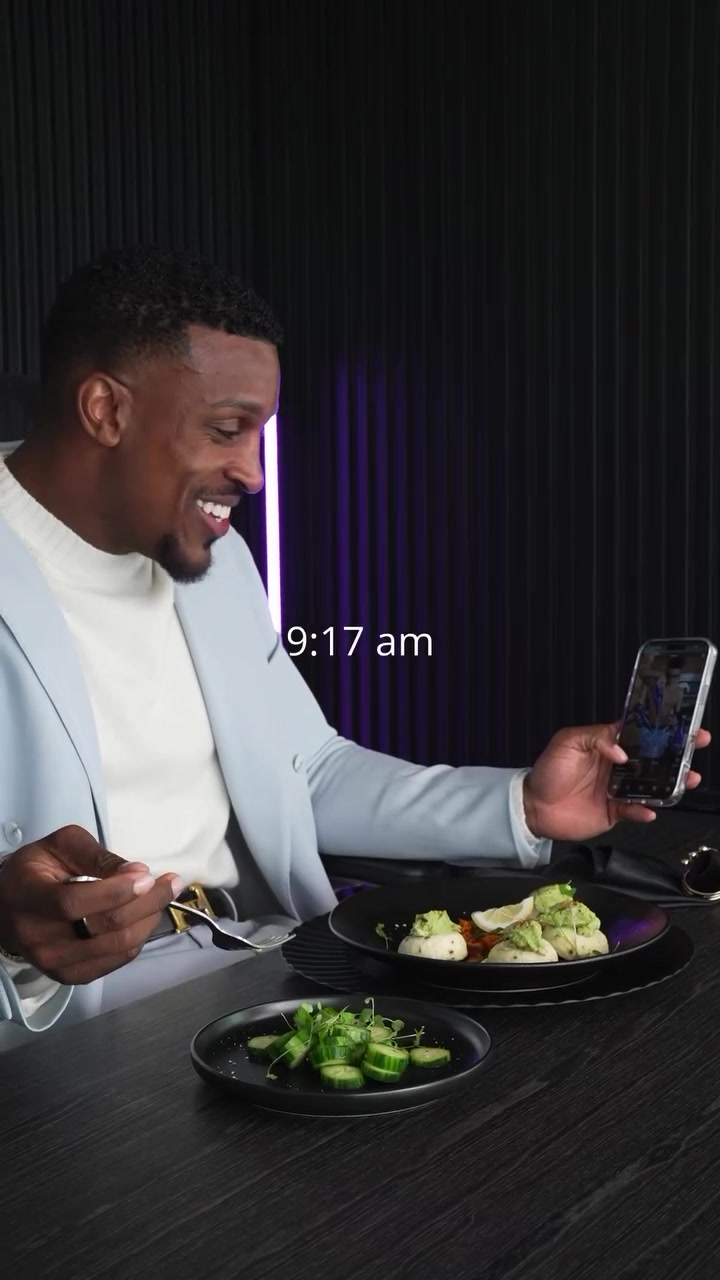 Ashton Hall reviewing content on his phone