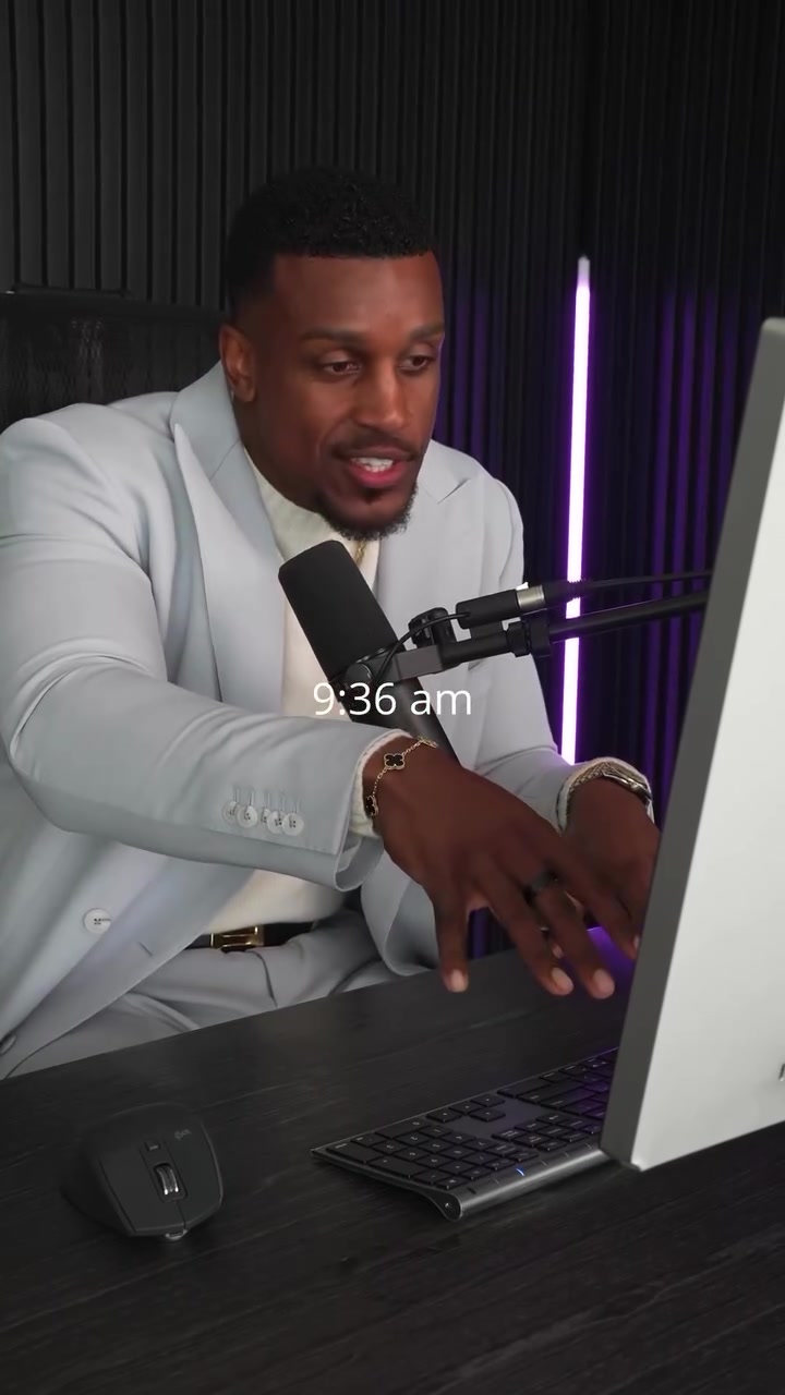 Ashton Hall leading a conversation from his desk